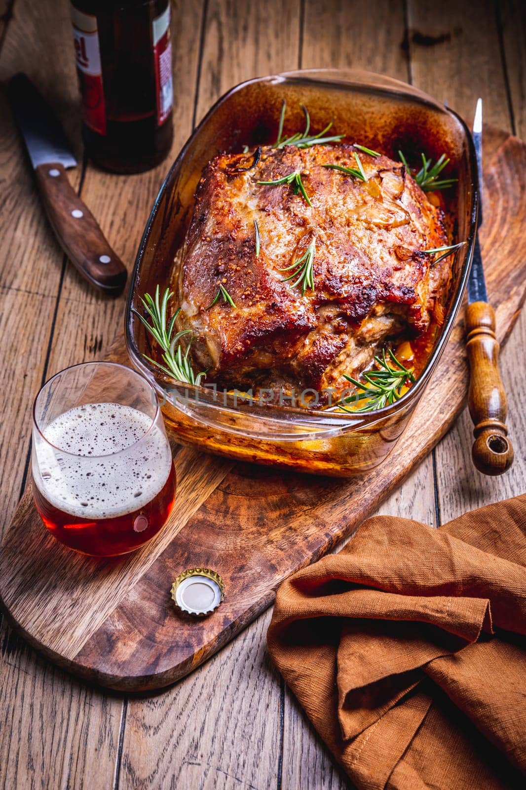 Roasted pork meat with potatoes, rosemary and beer sauce in casserole