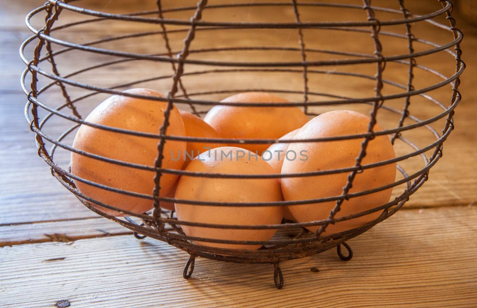 Old rusty wire egg cup. Country style background. Focus on wire