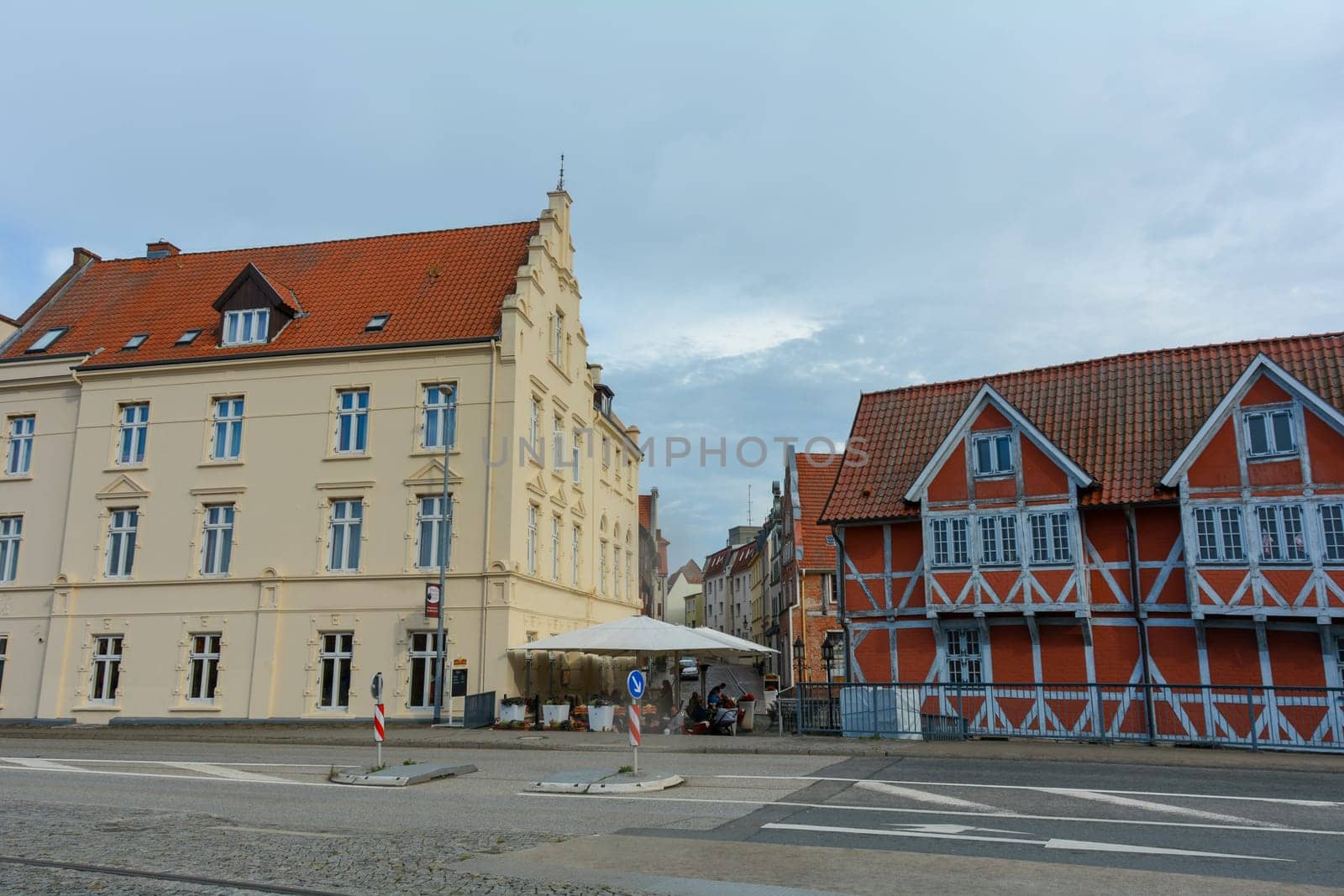 A red half-timbered house and a yellow house on a street in the historic Hanseatic city of Wismar, on the Baltic Sea coast of Mecklenburg-West Pomerania in Germany