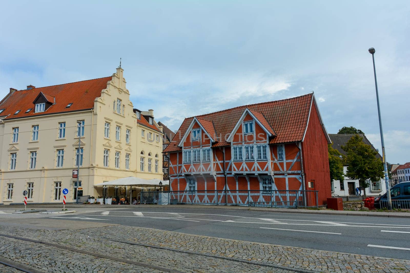 Red half-timbered house and a yellow house on a street in the historic Hanseatic city of Wismar, on the Baltic Sea coast of Mecklenburg-West Pomerania in Germany
