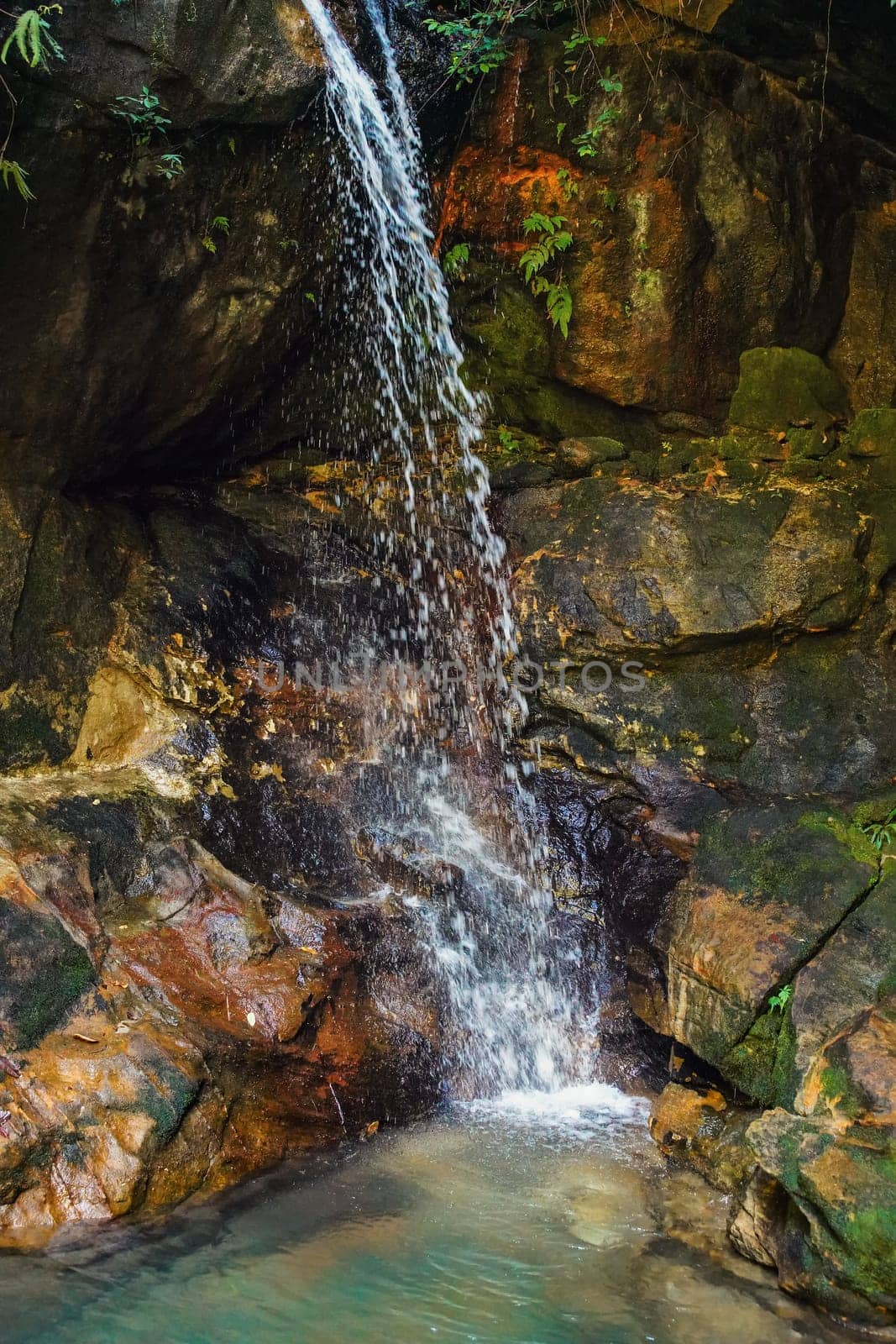 Small waterfall, with green pool under in Isalo park, Madagascar.