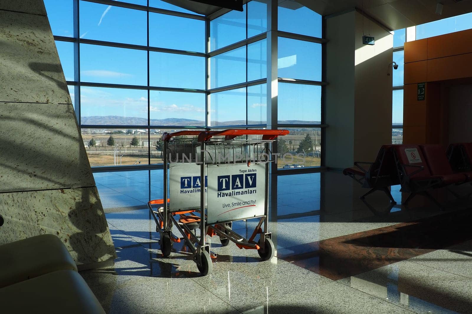 Ankara, Turkey, Esenboga Havalimani Airport, 01.18.2023 Boarding lounge. Sunlight through the windows. Empty luggage trolley. Airport interior. Travel and business. Lack of passengers in a crisis