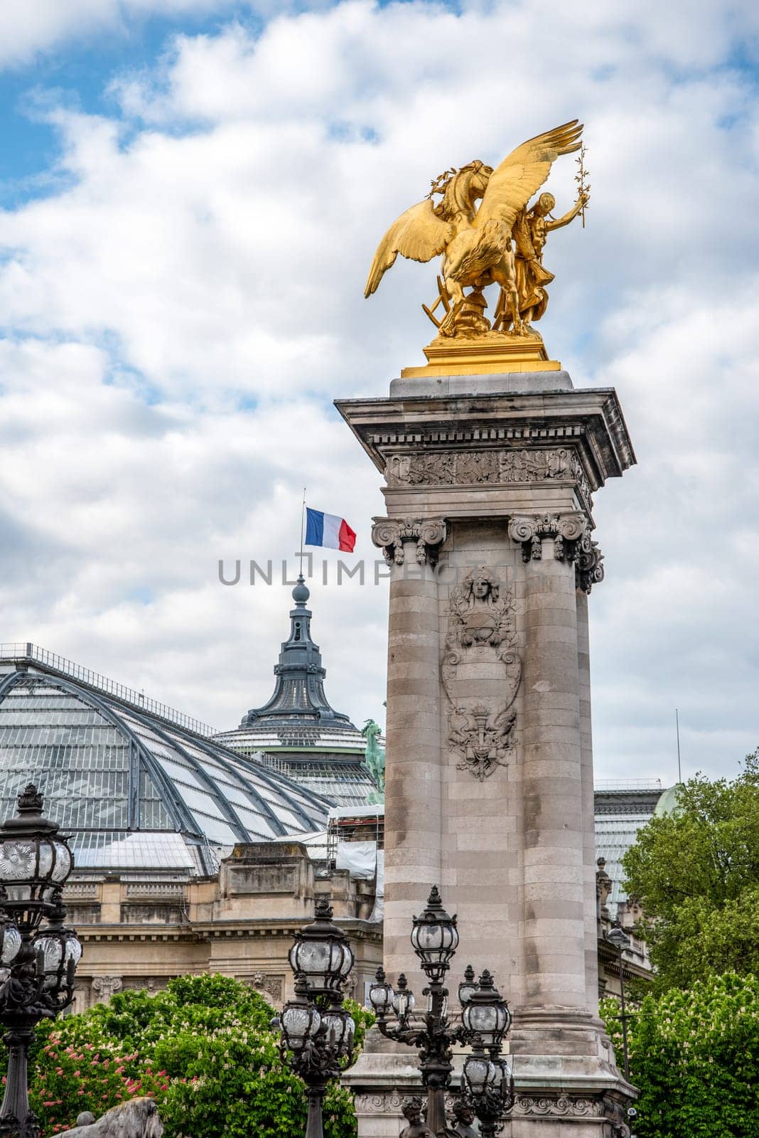 Column at the Bridge Alexandre III, the Grand Palais in the background, Paris, France