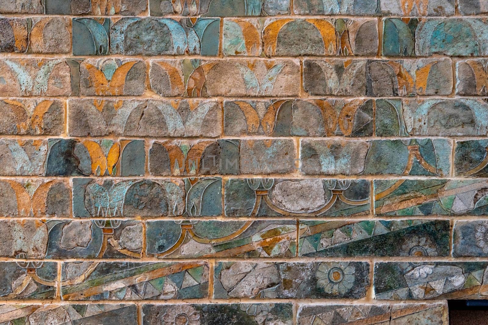 Colorful ancient Persian wall frieze in the Louvre museum in Paris, France