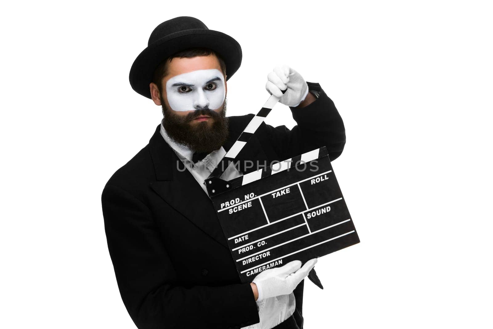 man in the image mime, dressed in black and white suit with movie board, isolated on a white background