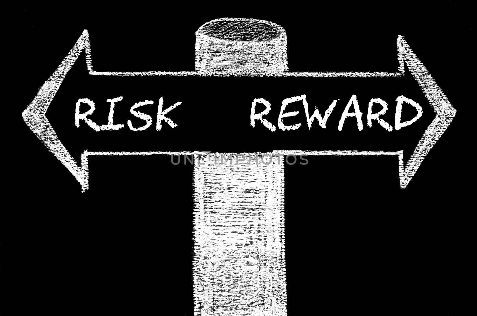 Opposite arrows with Risk versus Reward. Hand drawing with chalk on blackboard. Choice conceptual image