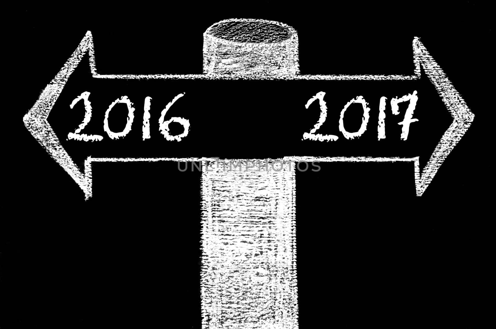 Opposite arrows with Year 2016 versus Year 2017. Hand drawing with chalk on blackboard. Choice conceptual image