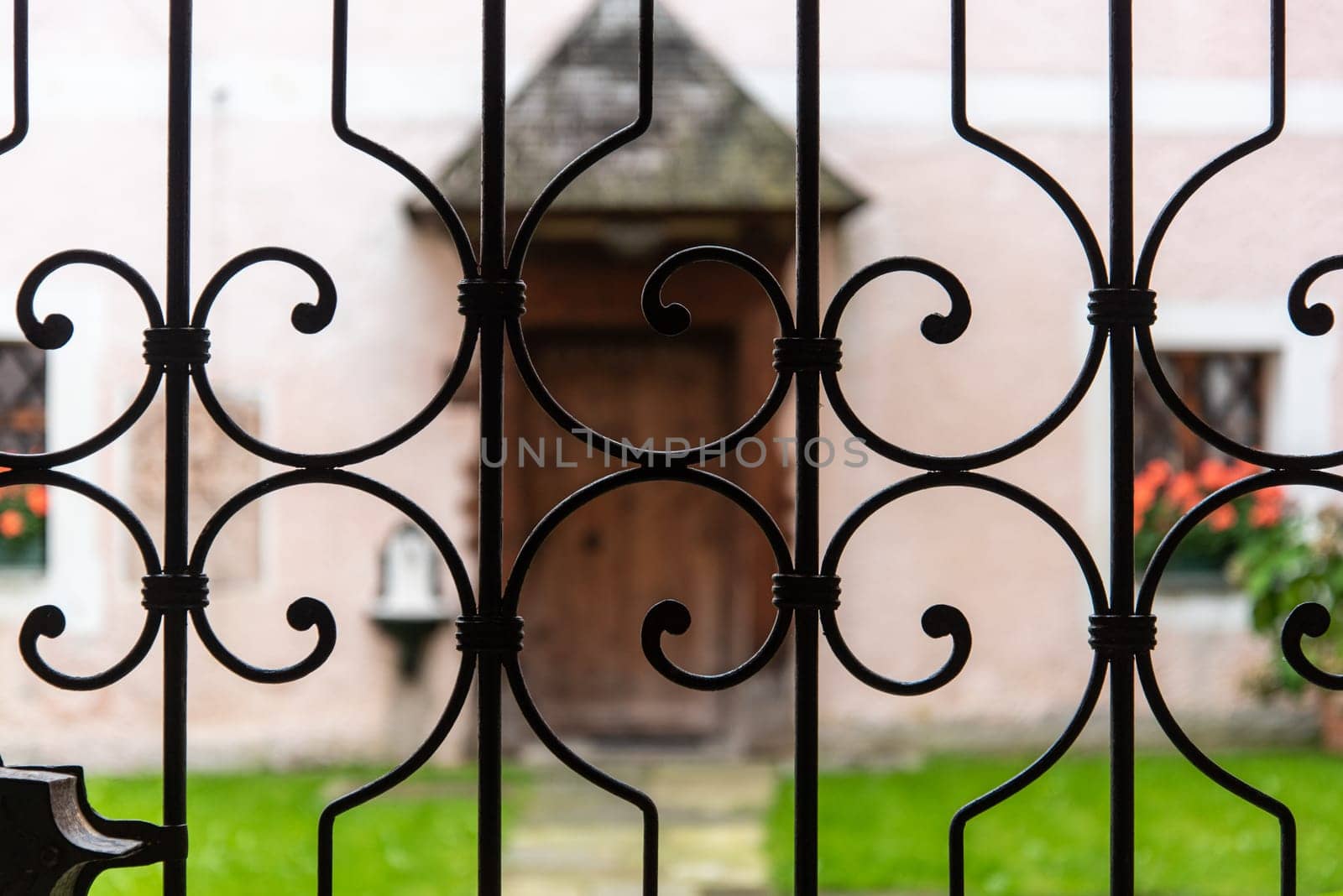 An old Fence cordoning the frontcourt of abandoned Monastery Hoeglwoerth, Bavaria, Germany