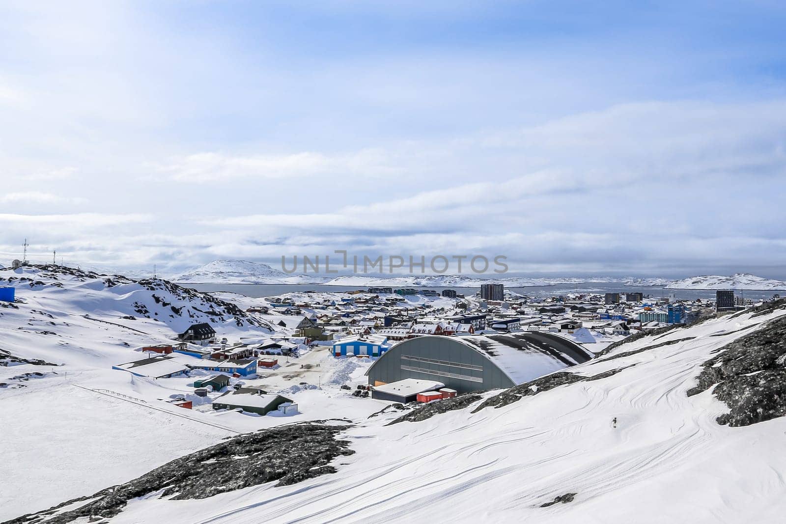Nuuk city covered in snow with sea and mountains in the background, Greenland