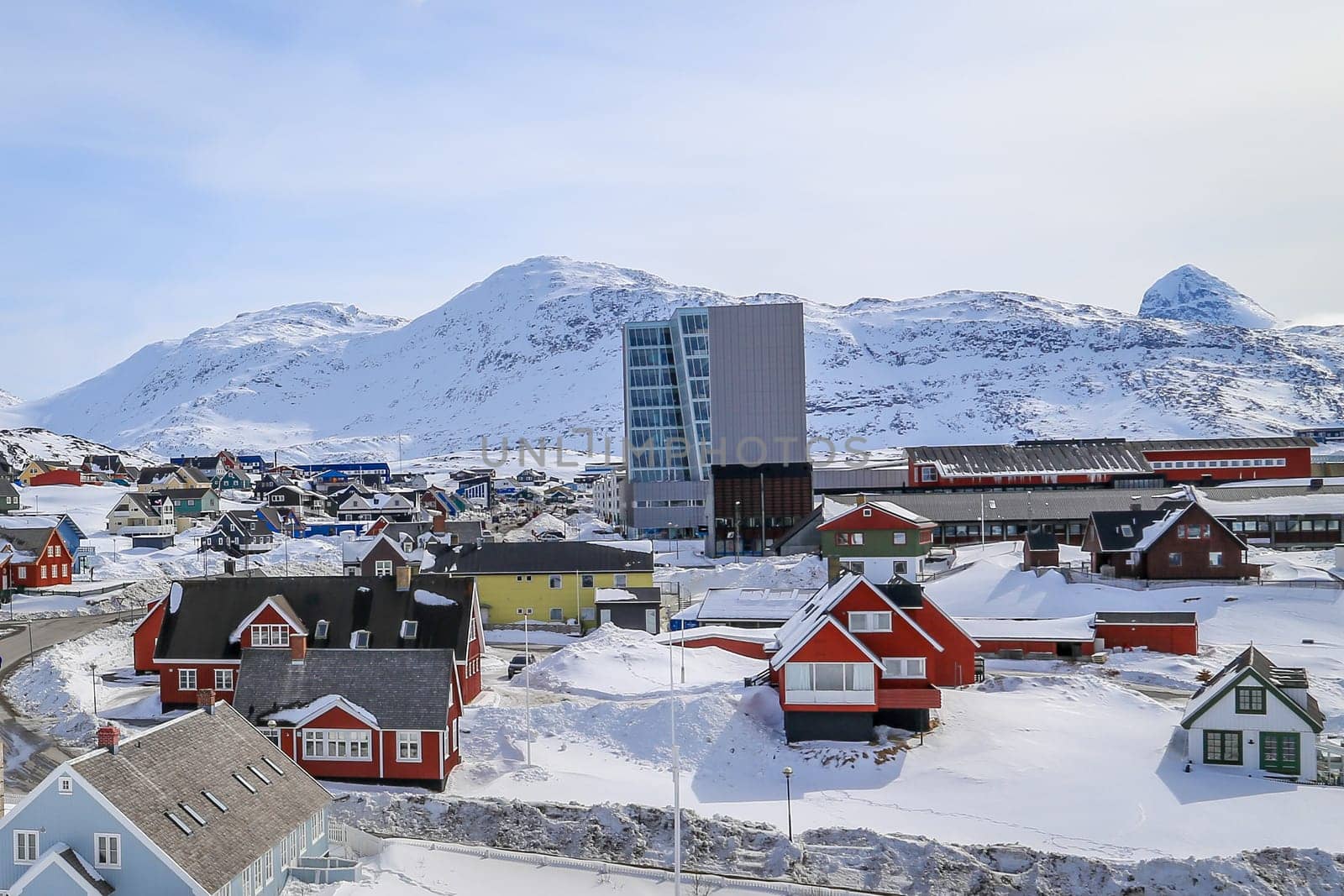 Nuuk city center streets with colorful Inuit houses covered in snow Nuuk with mountains in the background, Greenland