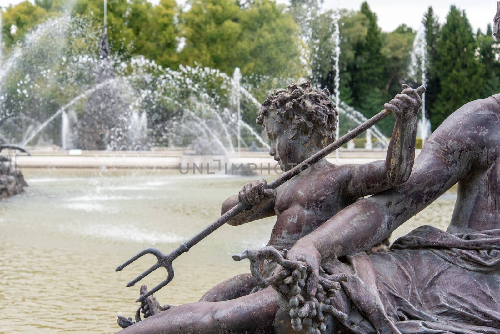 Sculpture of a little Boy with a Trident in the Palace Garden of Herrenchiemsee in Bavaria, Germany