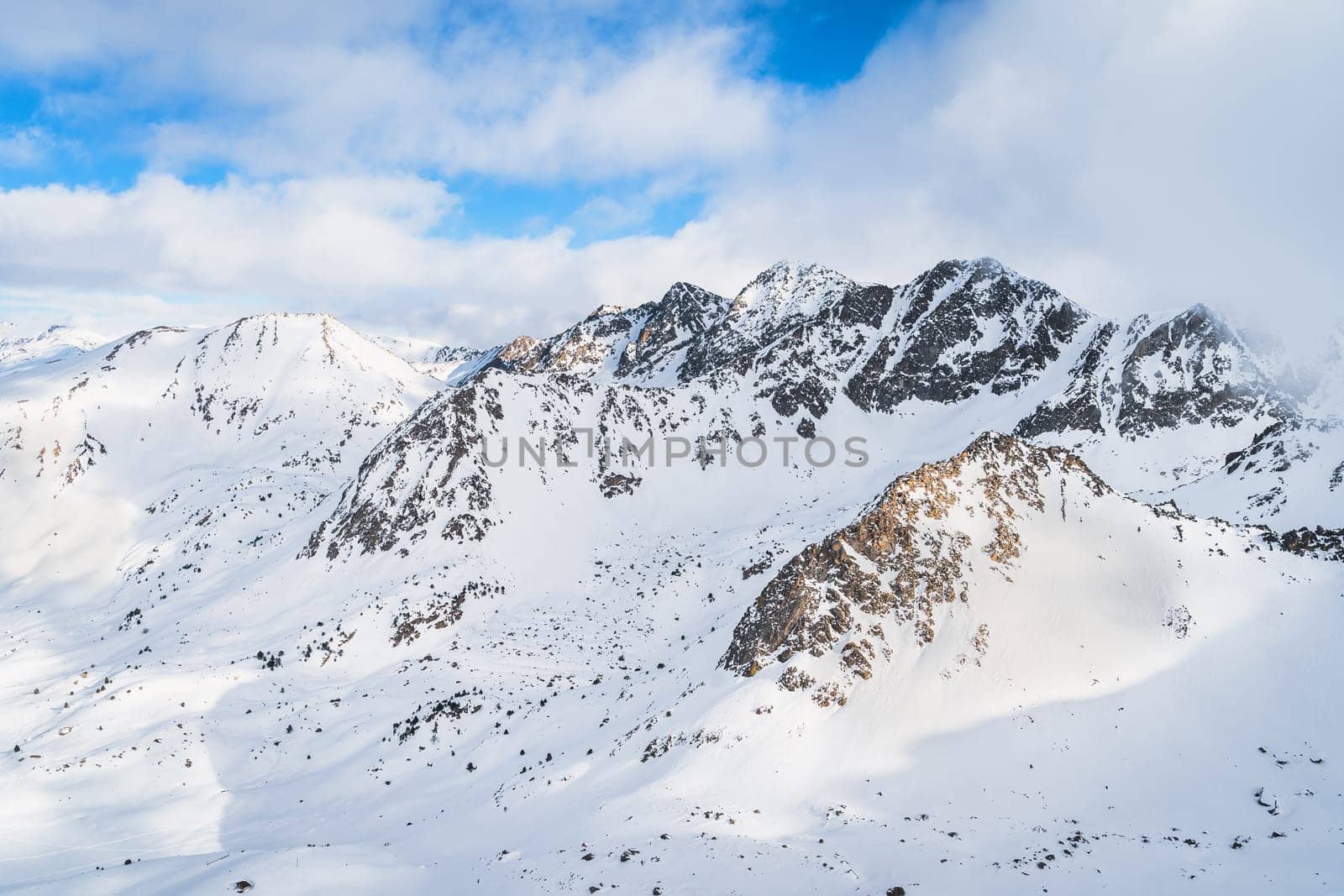 Dramatics mountain landscape with snow capped rocky Pyrenees mountains. Ski winter holidays in Andorra, El Tarter, Grandvalira