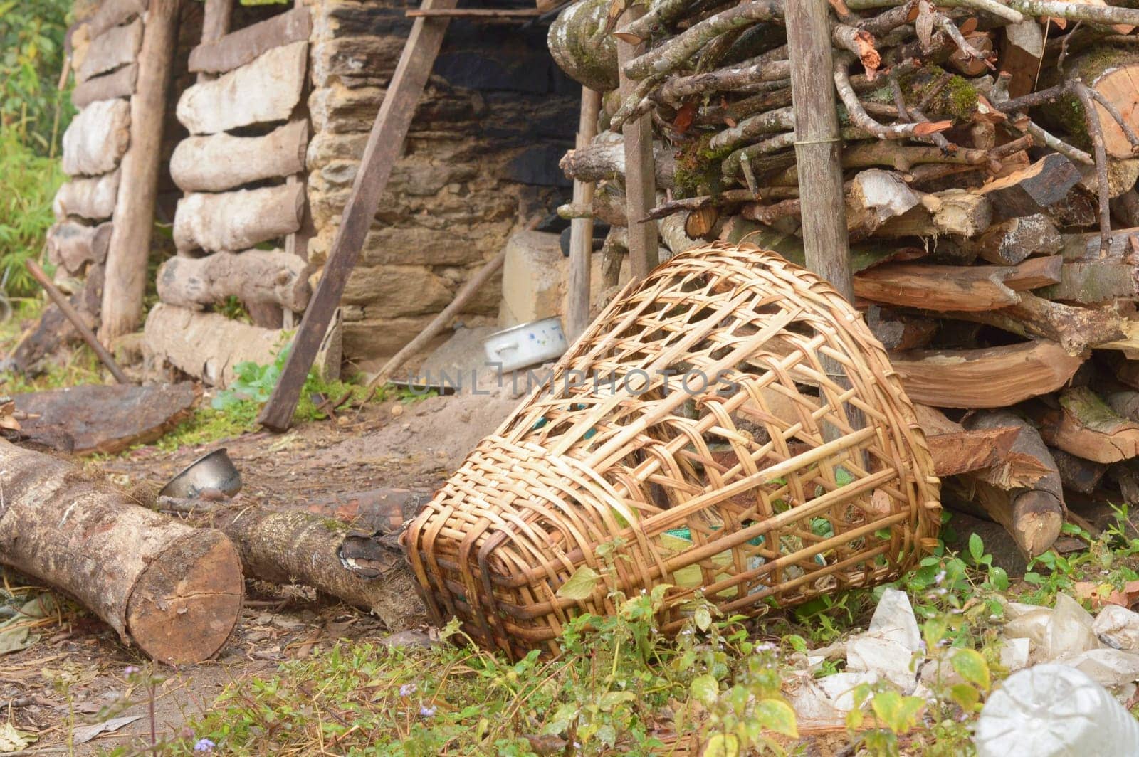 A Bamboo Basket laying in front of firewood storage room. Tabakoshi Rangbang, Mirik, West Bengal India .