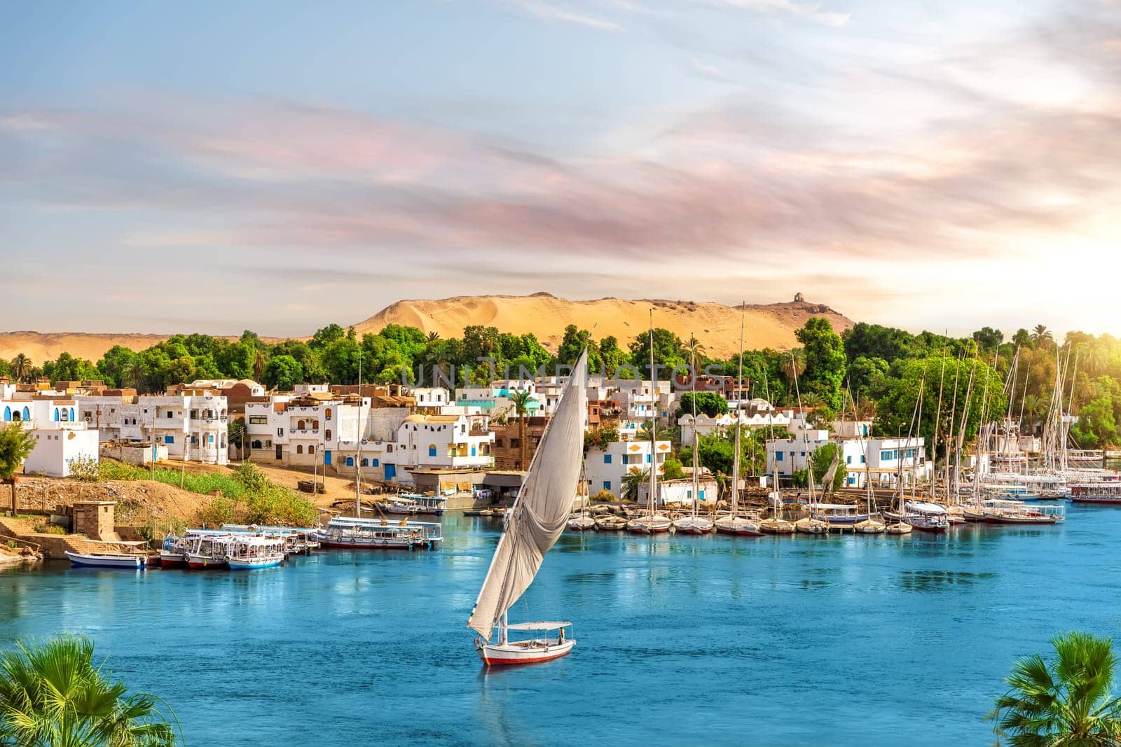 Picturesque buildings of Aswan, the Nile and sailboats, Egypt.