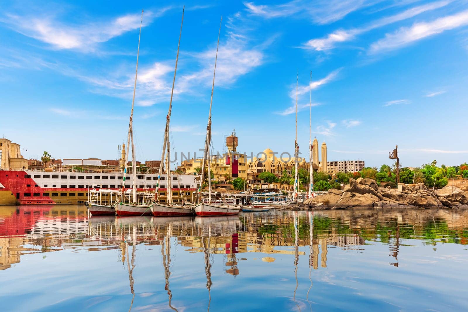 Sailboats in The Nile near the Coptic Orthodox Cathedral of the Archangel Michael, Aswan, Egypt.
