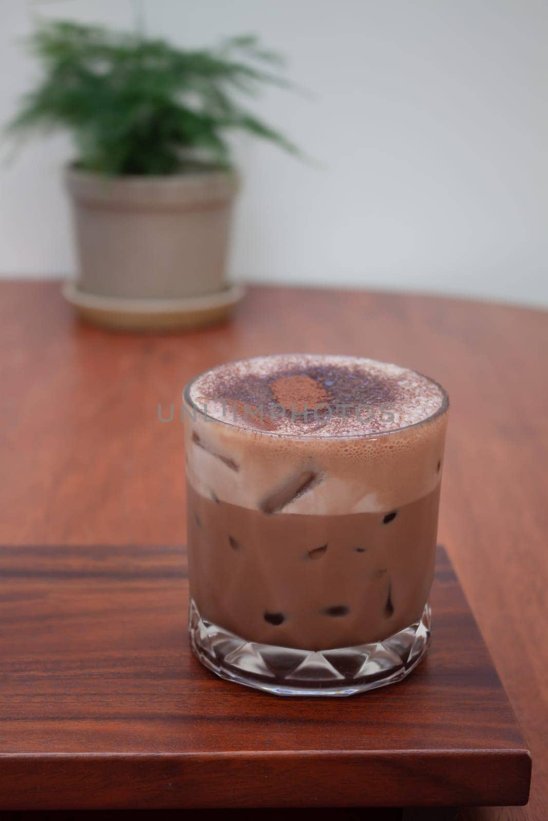 Iced coffee with micro foam in coffee shop, stock photo