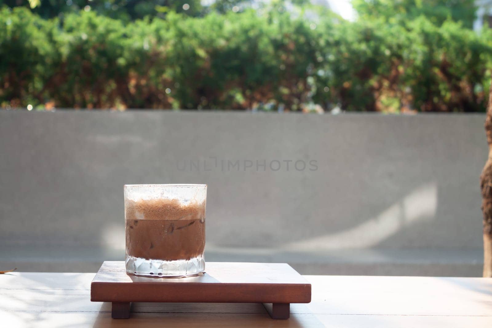 Iced coffee with micro foam in coffee shop, stock photo