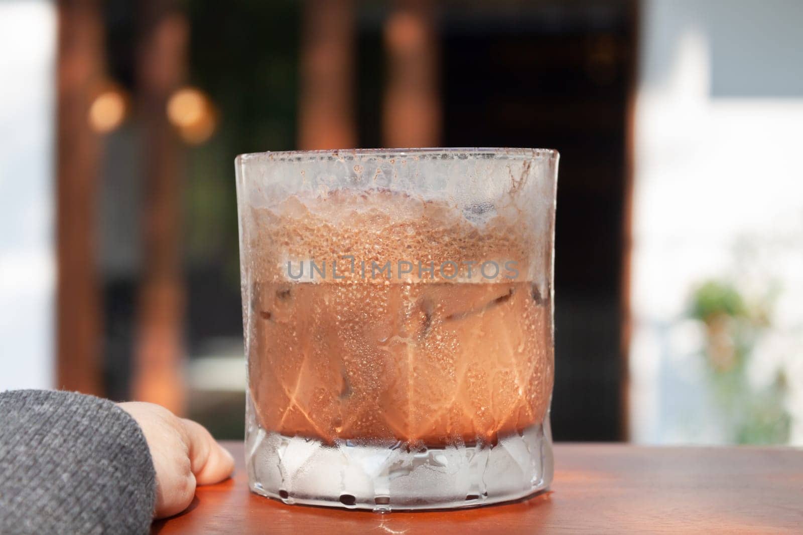 Iced coffee with micro foam in coffee shop, stock photo