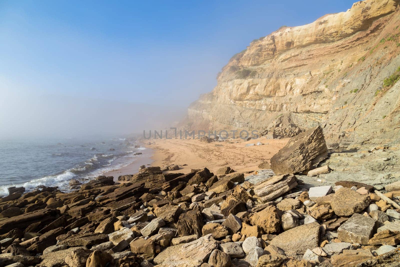 Beautiful empty beach in Alentejo in a foggy day, Portugal