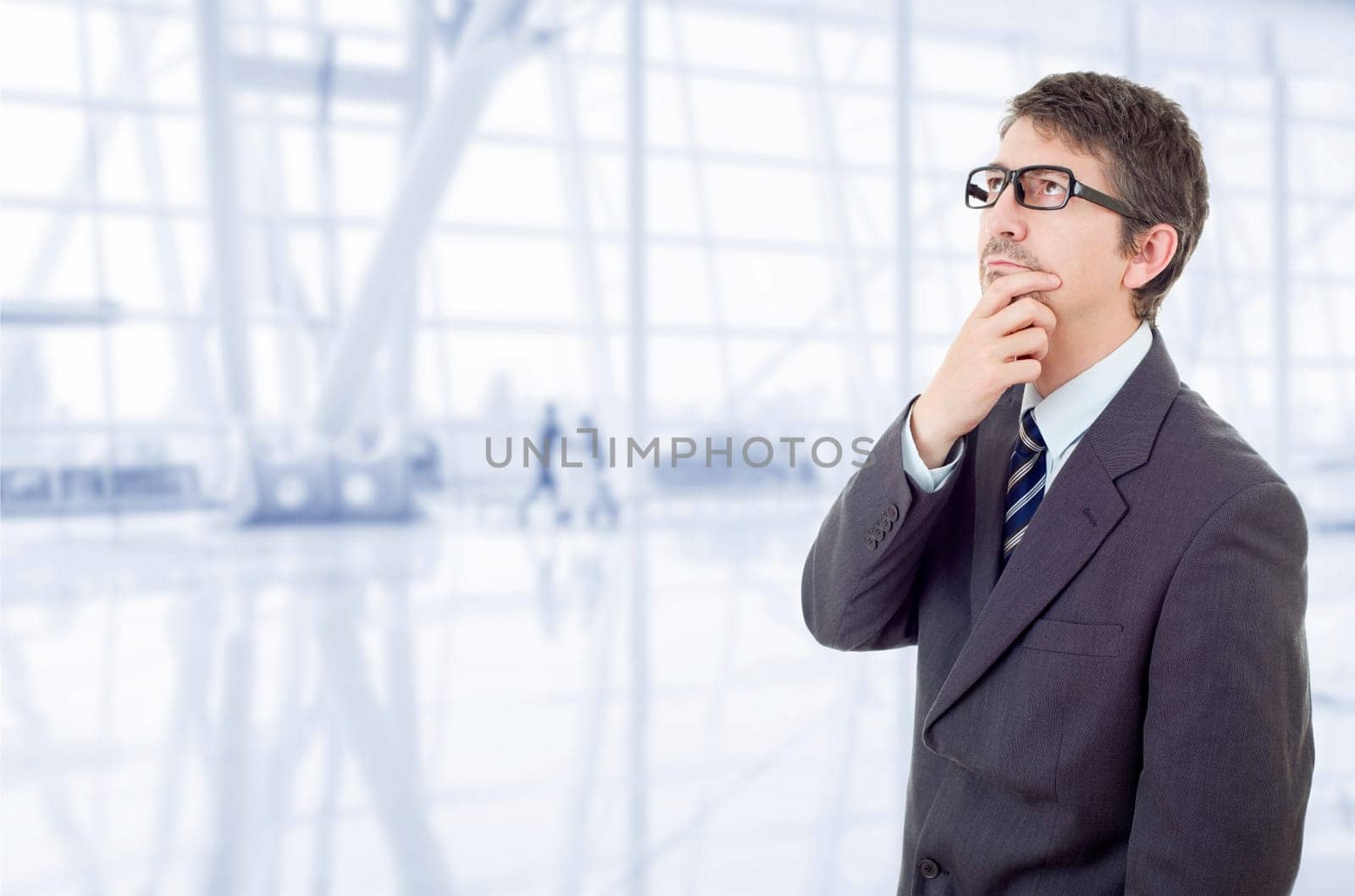 young business man thinking, at the office