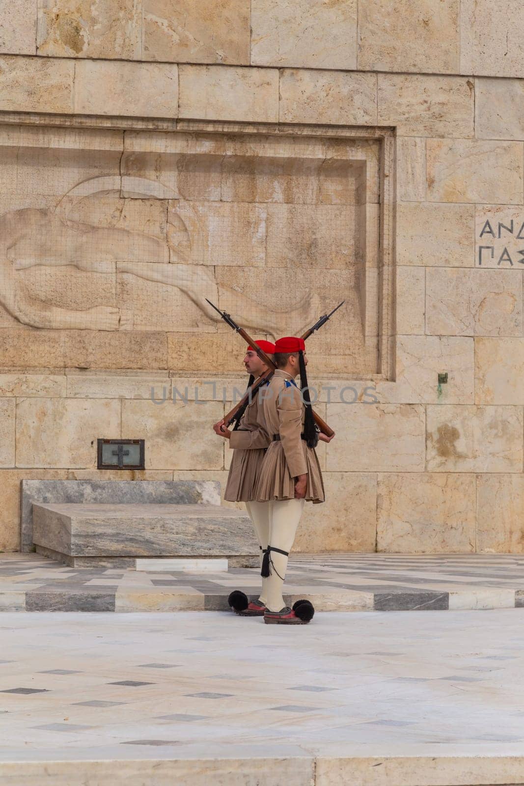ATHENS, GREECE - MAY 06 2022: Presidential ceremonial guards - Evzones at the Tomb of the Unknown Soldier in front of the Greek Parliament, Athens, Greece