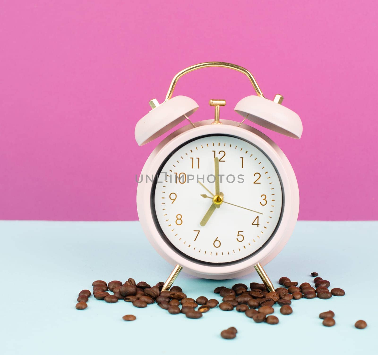 Alarm clock with roasted coffee beans, wake up in the morning, time to stand up, hot drink for breakfast