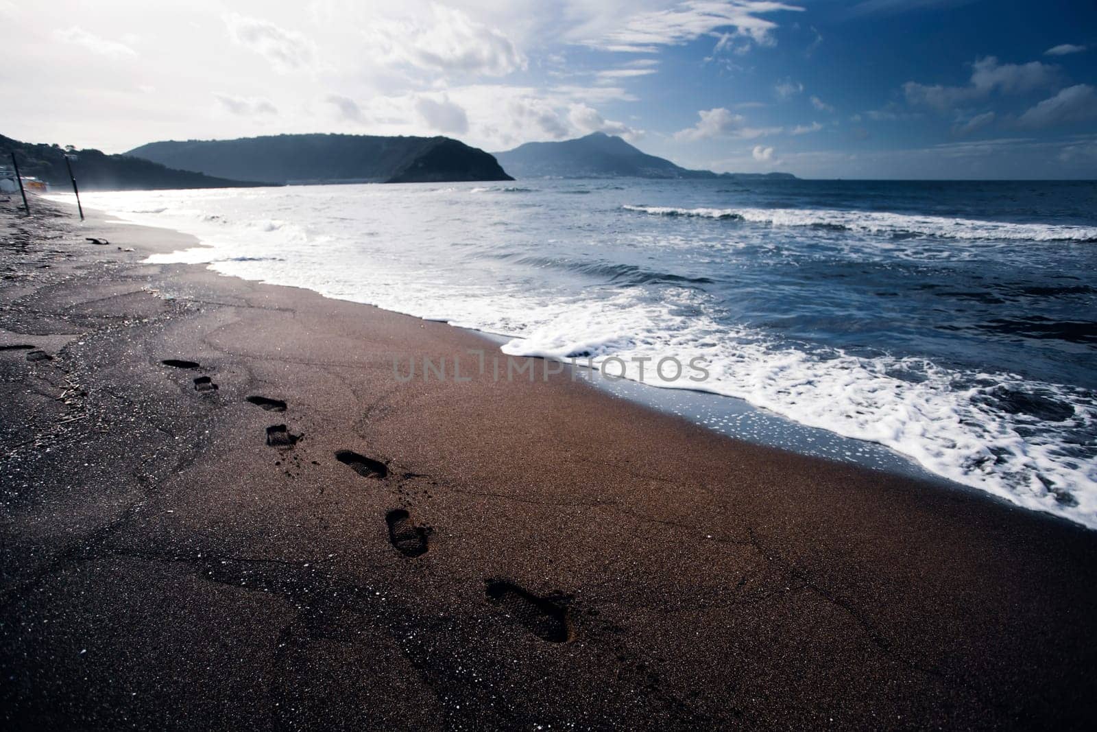 Footsteps in the sand on a beautiful italian beach.