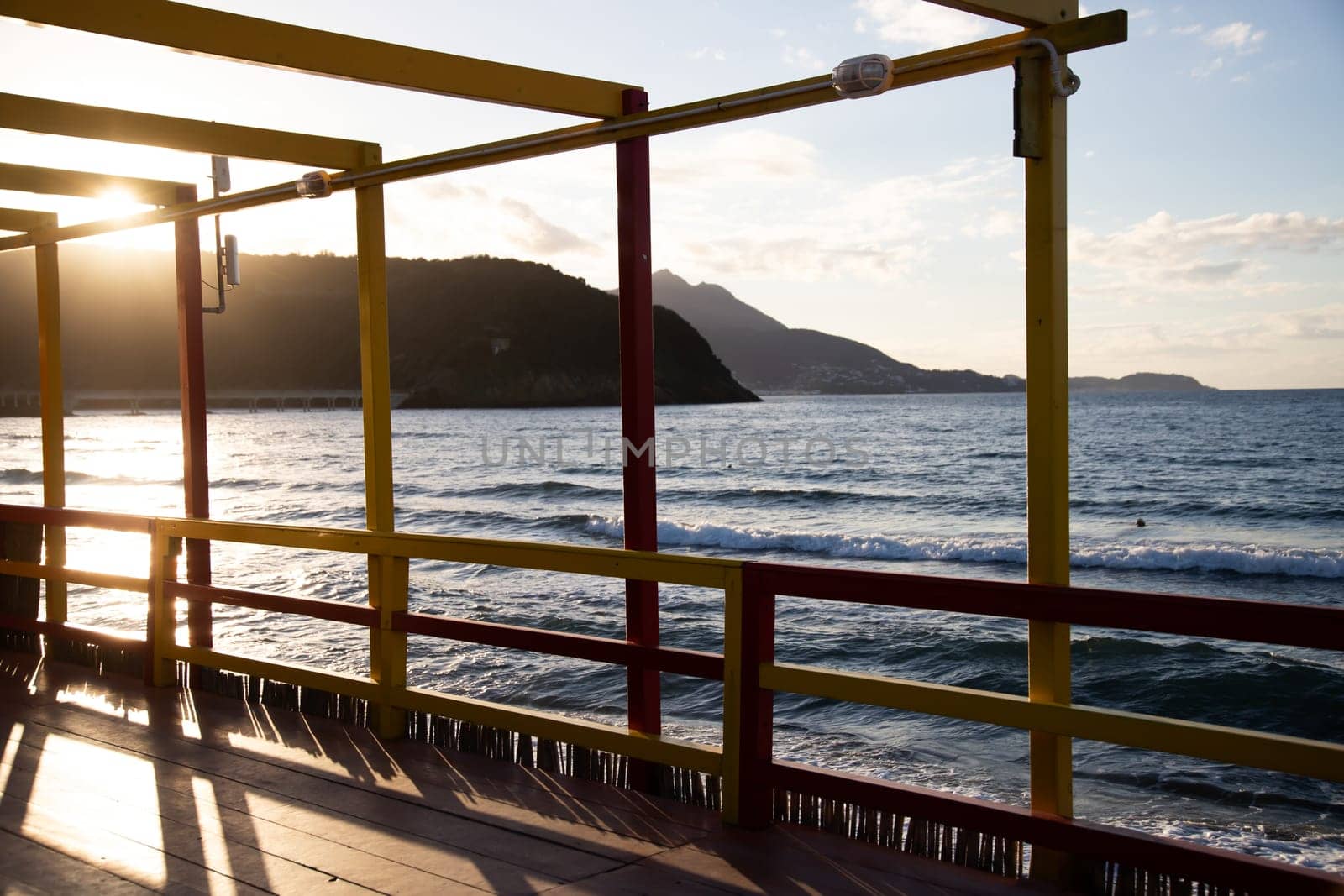 Cozy terrace on the beach, idyllic view of the seashore. Tropical summer vacation concept.