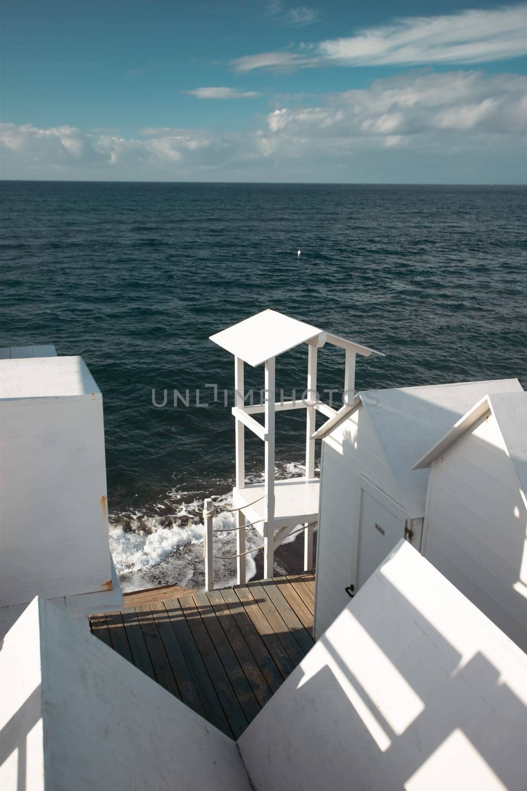 Traditional white wooden beach huts on the beach of Ciraccio, Procida island, Italy