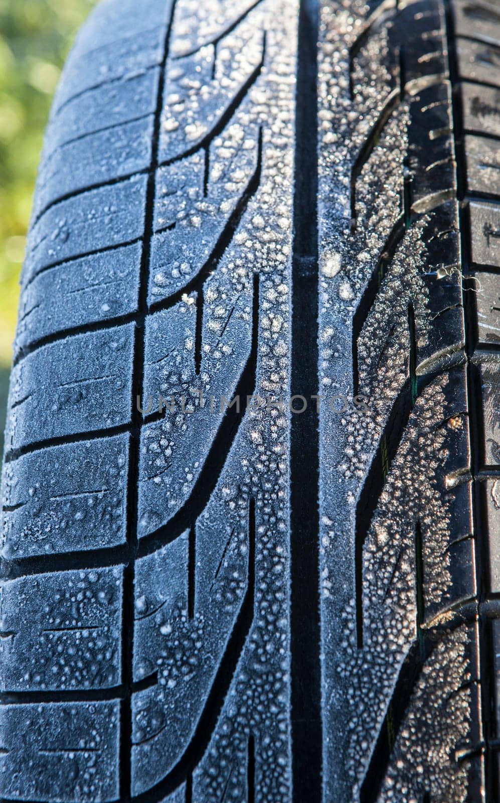 Frost covered tire surface. Safe driving on winter concept