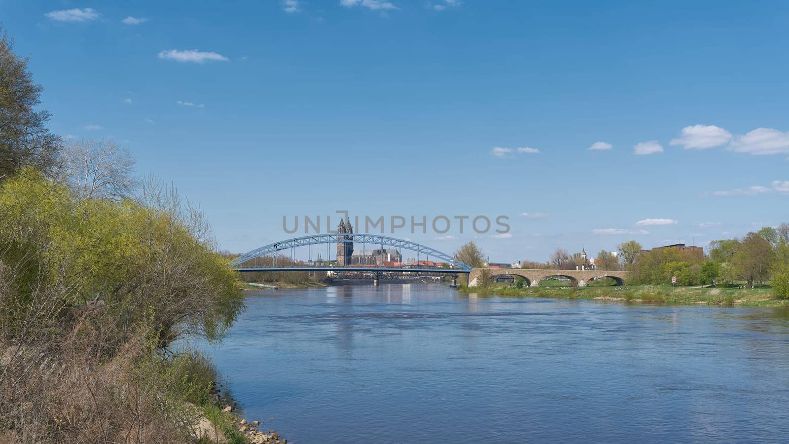 Silhouette of the city of Magdeburg on the river Elbe with Magdeburg Cathedral and Sternbrucke bridge in the foreground