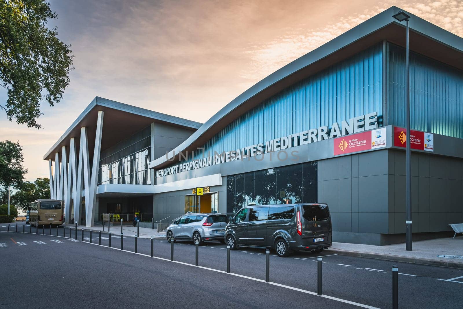 Perpignan, France, Jan Building, exterior of Perpignan Rivesaltes Mediterranean airport at dramatic sunrise. Taxis waiting for passengers
