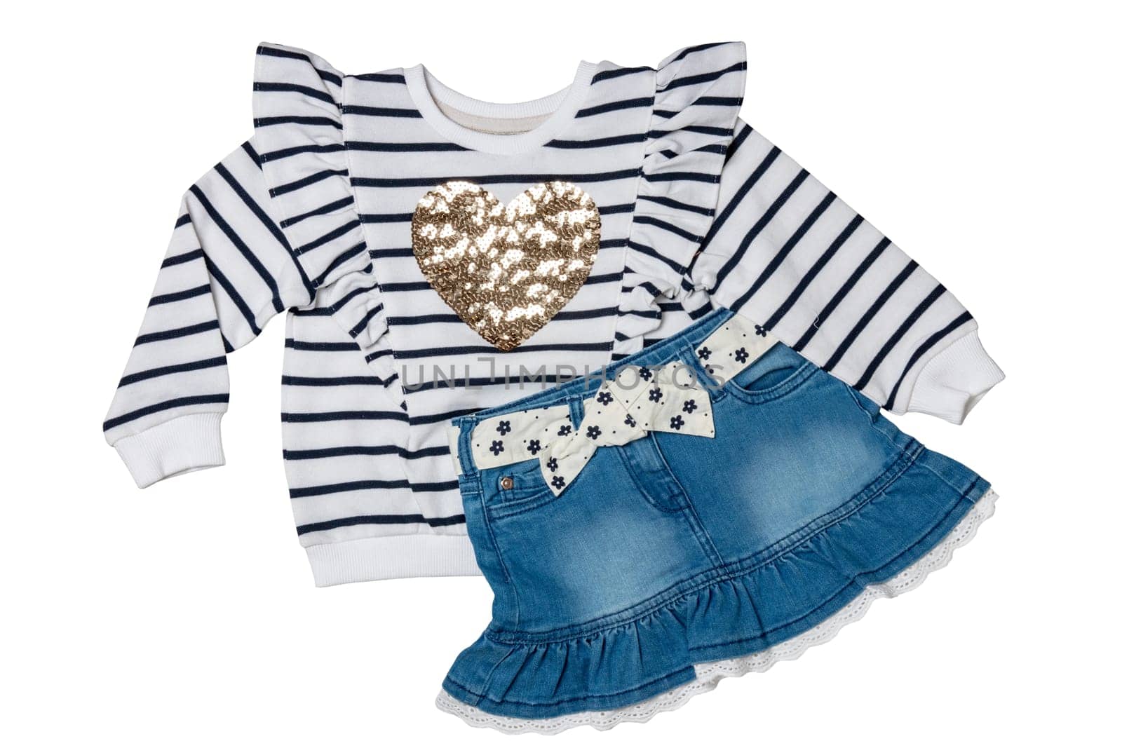 A black and white striped sweater or pullover with a heart and a sexy short blue denim skirt with a white fabric belt with flowers and bow isolated. Clipping path.
