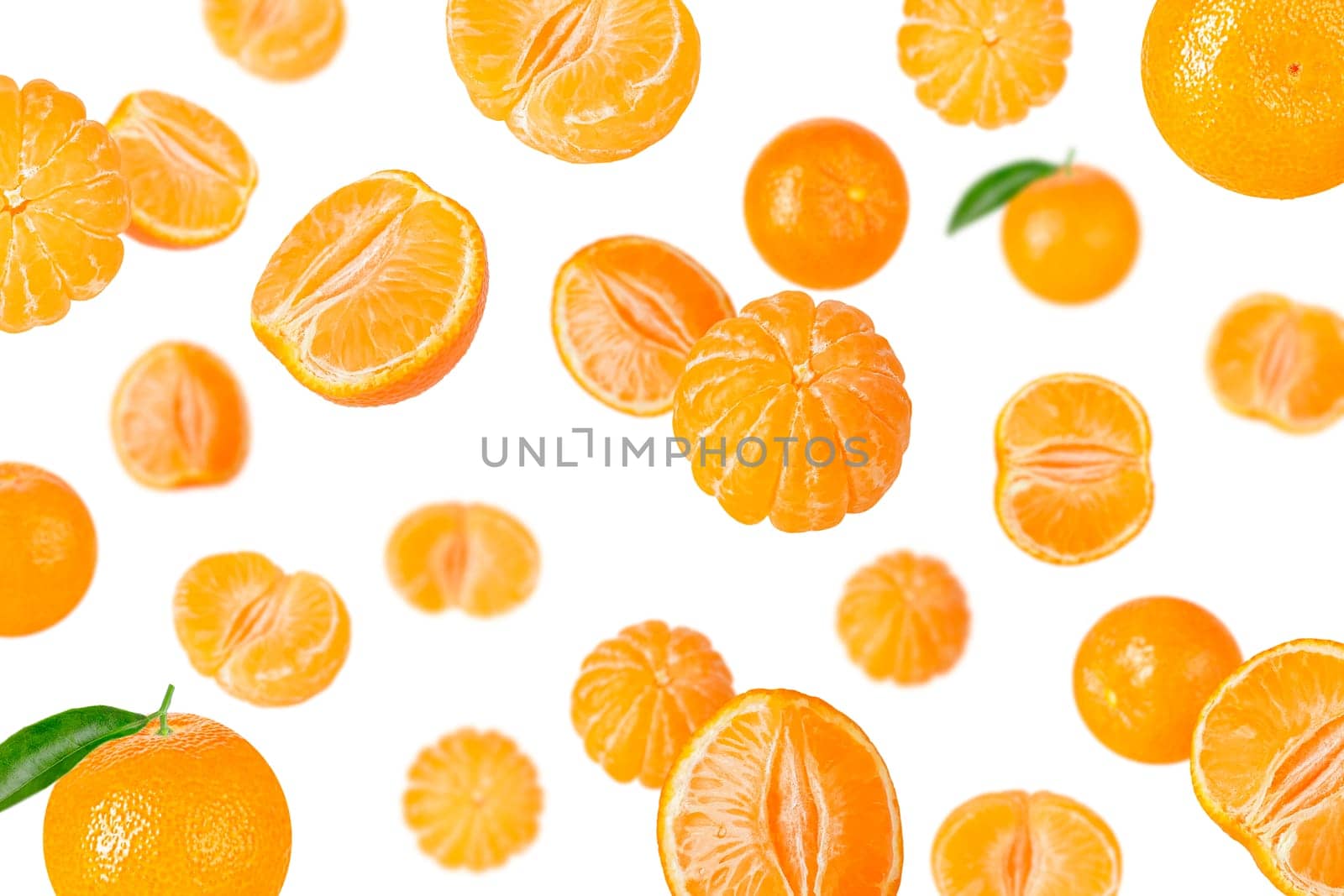 Creative levitation pattern with whole and pieces peeled tangerines. Selective focus. Isolated fruit. Packaging concept. Clip art image for package design.
