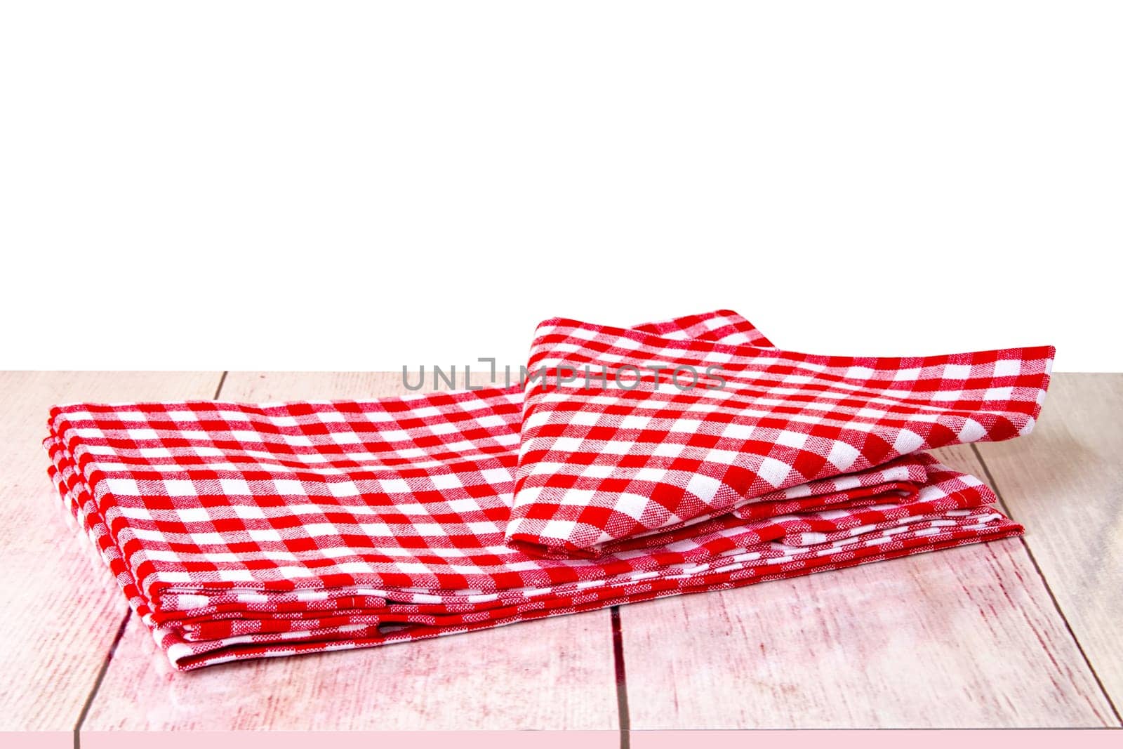 Empty wooden bright desk table with red checkered tablecloth isolated on a white background. Template for your food and product display montage.