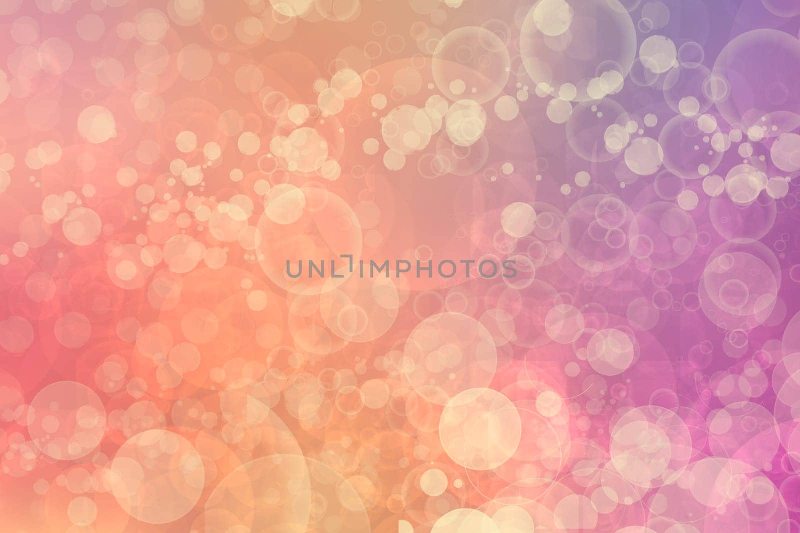 A festive abstract orange pink yellow gradient background texture with glitter defocused sparkle bokeh circles. Card concept for Happy New Year, party invitation, valentine or other holidays.