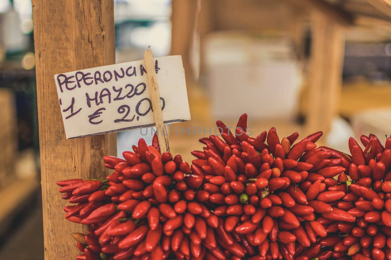 Venice, Italy, November 2014: bunch of peppers for sale in Italy. Price tag in euro visible. Close-up and selective focus.