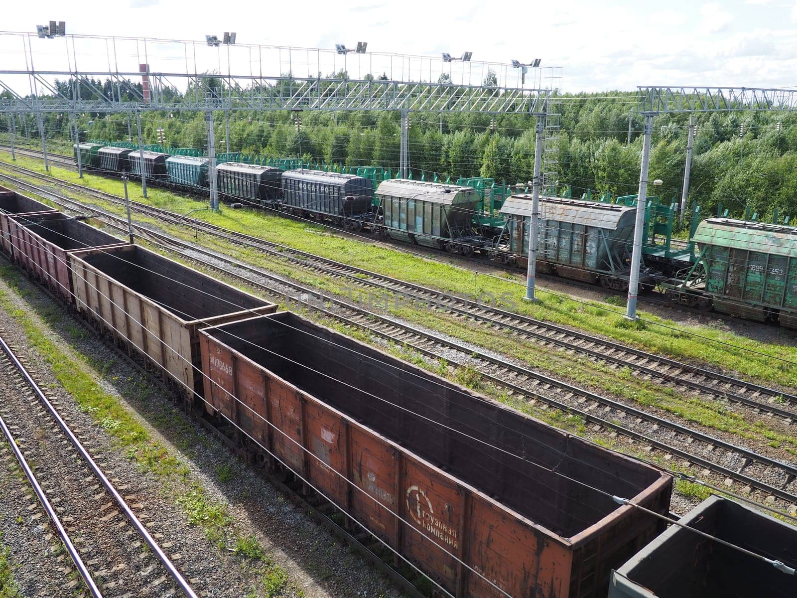 Svir, Russia August 6, 2021. Freight trains and wagons from above. Railroad on a summer day. Transportation, cargo, logistics and business process. Empty metal wagons. International cargo transport