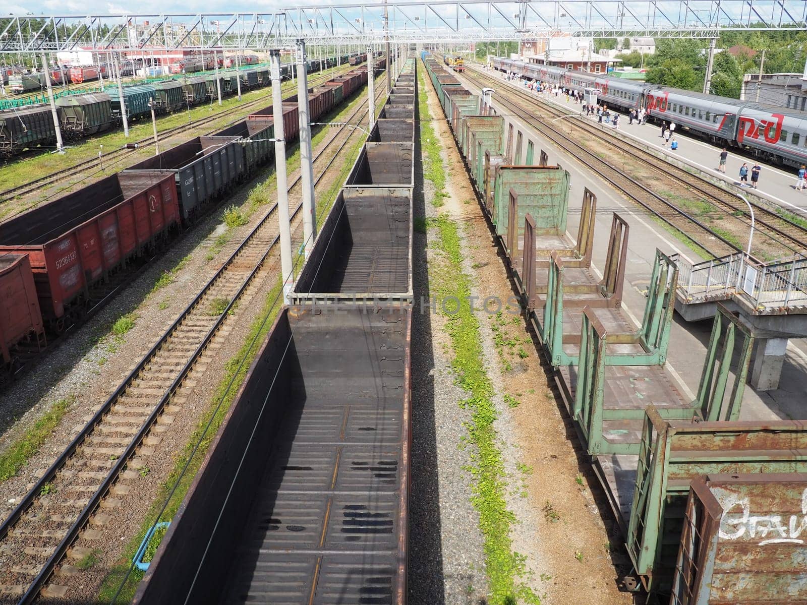 Svir, Russia August 6, 2021. Freight trains and wagons from above. Railroad on a summer day. Transportation, cargo, logistics and business process. Empty metal wagons. International cargo transport.
