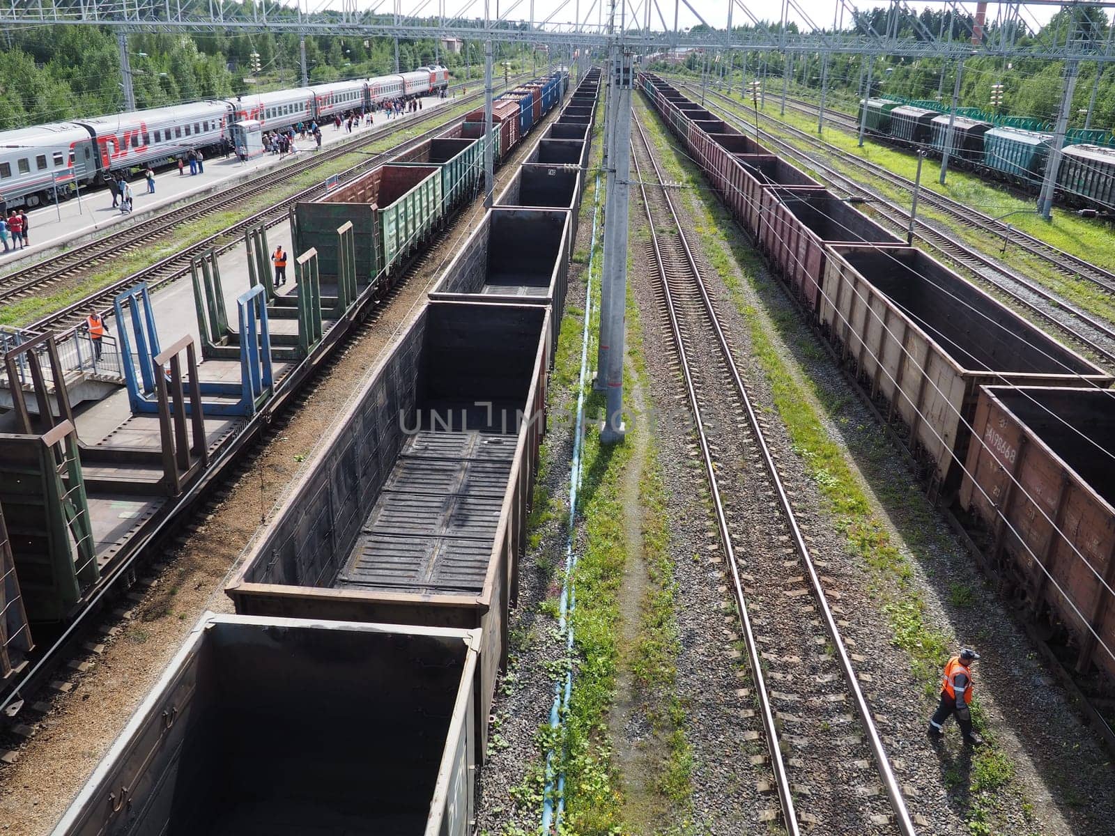 Svir, Russia August 6, 2021. Freight trains and wagons from above. Railroad on a summer day. Transportation, cargo, logistics and business process. Empty metal wagons. International cargo transport.