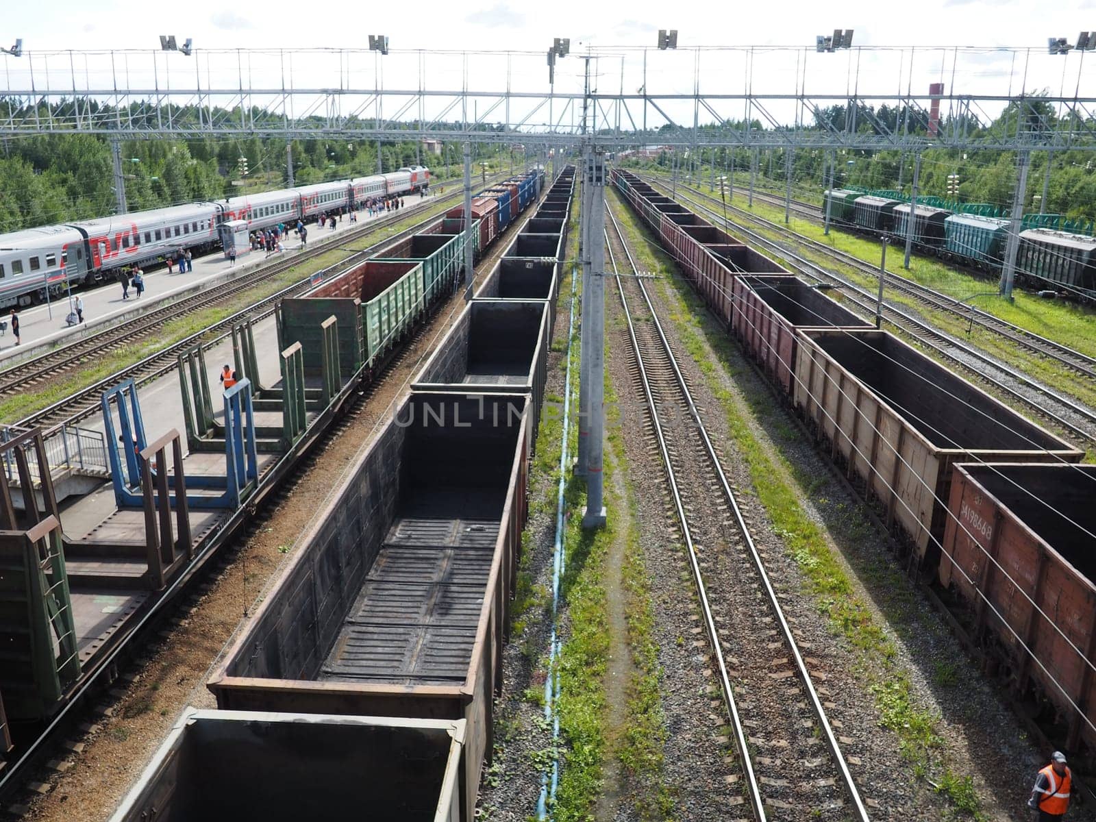 Svir, Russia August 6, 2021. Freight trains and wagons from above. Railroad on a summer day. Transportation, cargo, logistics and business process. Empty metal wagons. International cargo transport.