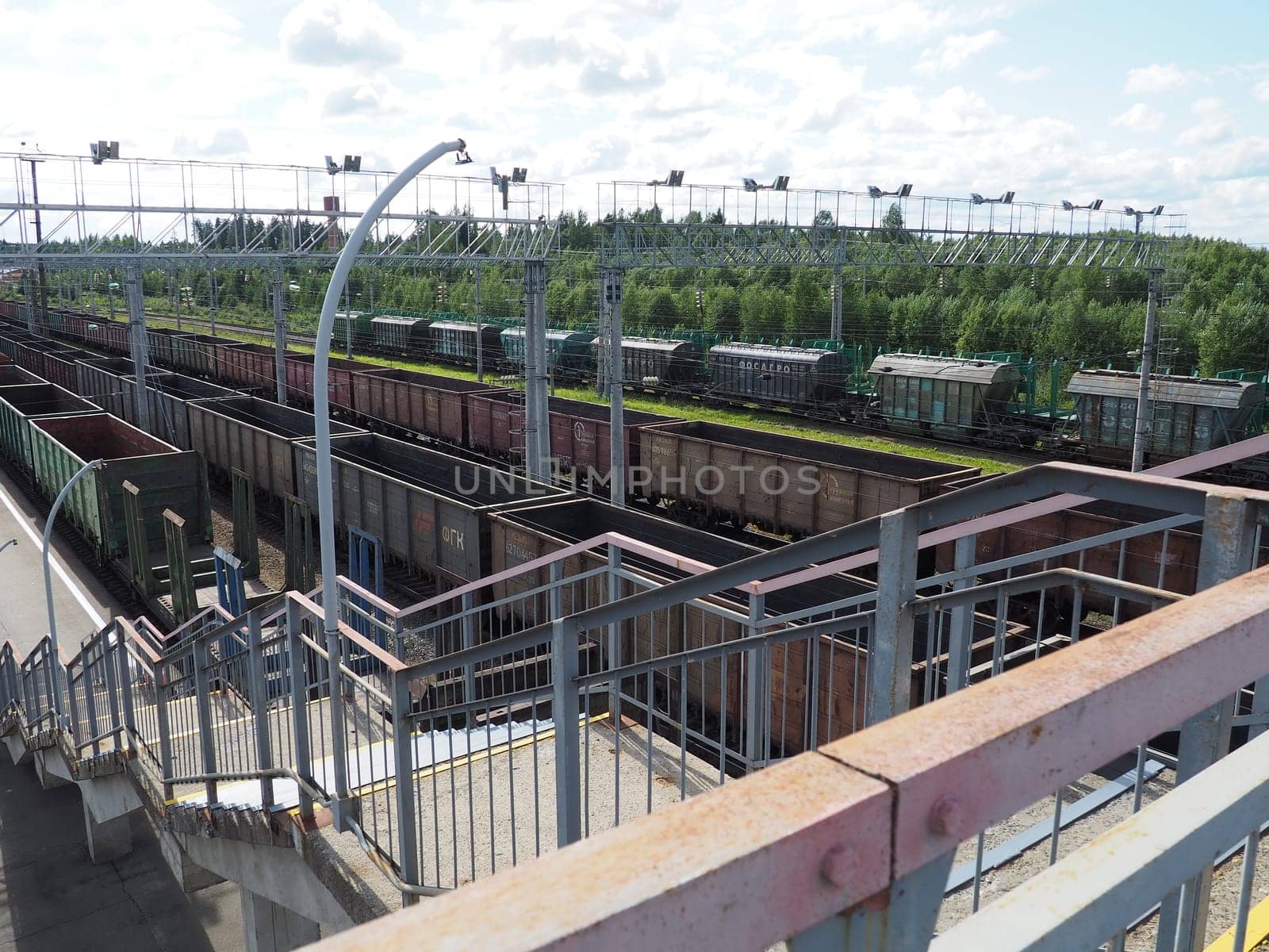 Svir, Russia August 6, 2021. Freight trains and wagons from above. Railroad on a summer day. Transportation, cargo, logistics and business process. Empty metal wagons. International cargo transport.