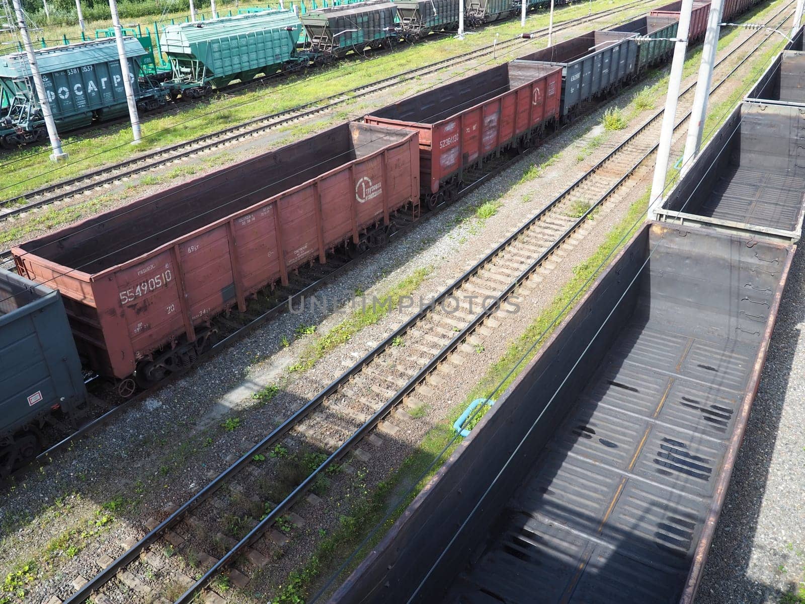 Svir, Russia August 6, 2021. Freight trains and wagons from above. Railroad on a summer day. Transportation, cargo, logistics and business process. Empty metal wagons. International cargo transport.