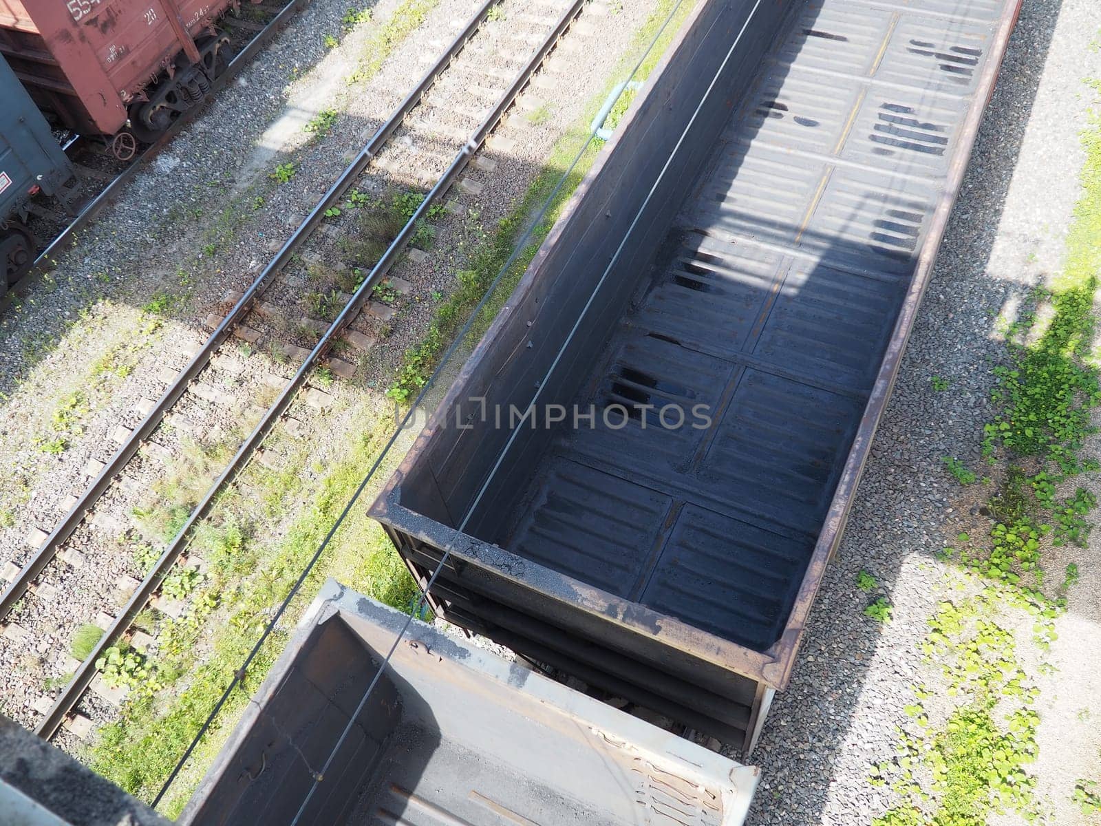 Svir, Russia August 6, 2021. Freight trains and wagons from above. Railroad on a summer day. Transportation, cargo, logistics and business process. Empty metal wagons. International cargo transport.