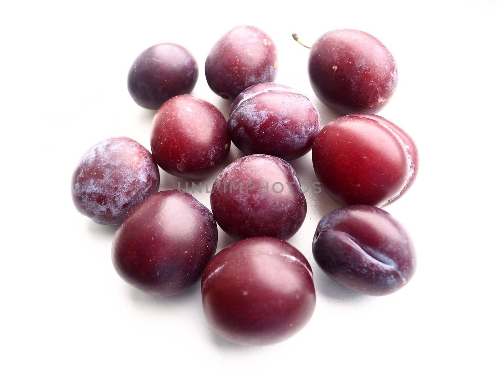 plums on a white background. Juicy ripe fruits.
