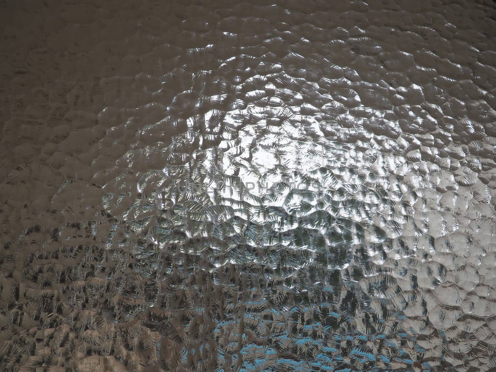 corrugated glass with a light and dark background. reflections of light. Close up and copy space.
