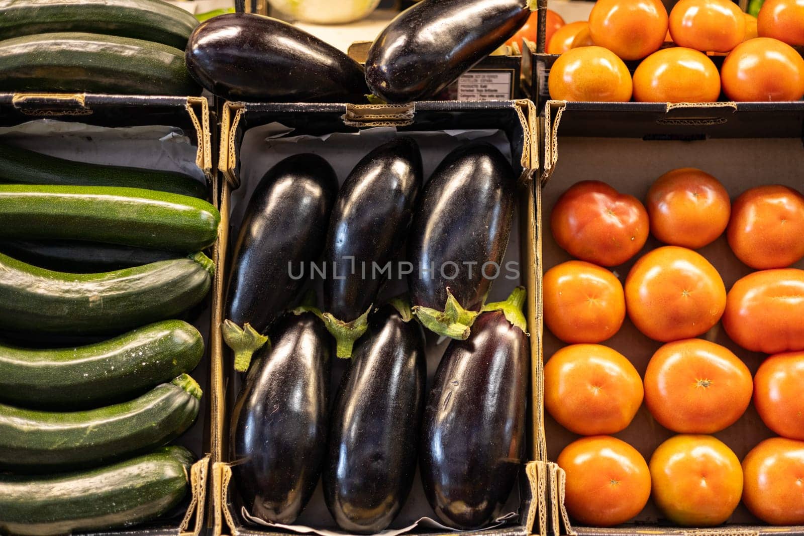 Colorful organic summer bio vegetables, tomatoes, zucchini and eggplant in boxes being sold on local fruit and vegetables market