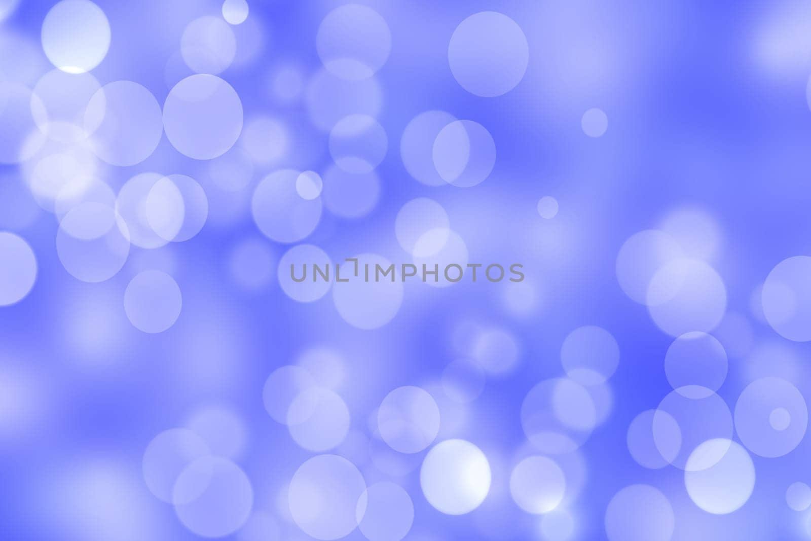 Abstract festive gradient blue white silver bokeh background texture with white bokeh lights. Beautiful backdrop with space for christmas, invitation, or other holidays.