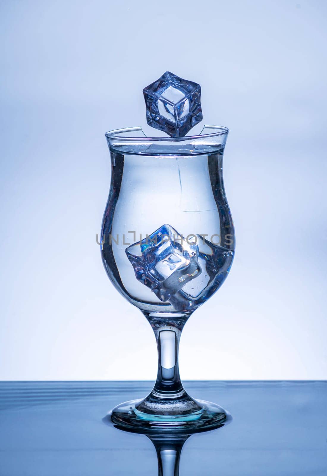 The image of pouring drinking water, into a broken glass, that makes one feel refreshed on blurred white background, Splashing water, Sparkling water, Danger or imminent danger concept