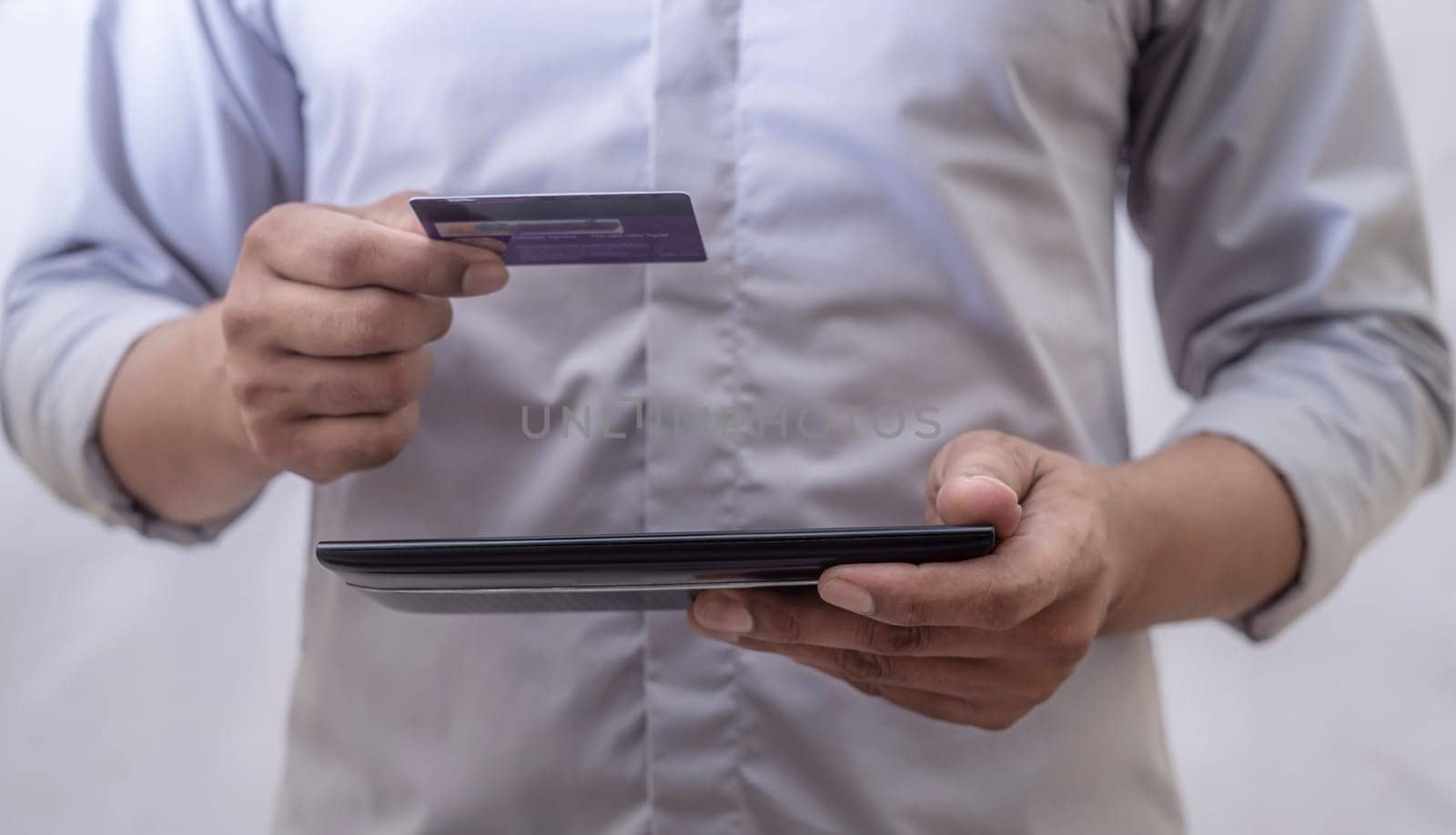 Online shopping and online banking and internet banking concept, Business man with phone, smart phone, mobile phone, laptop and credit card on white background, Investor and investing concept